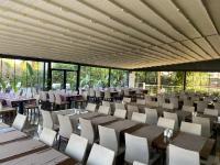 a dining room with tables and chairs and windows at B Business Hotel & Spa in Antalya