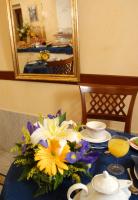 a table with a bouquet of flowers and a mirror at Hotel Ca&#39; Formenta in Venice