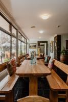 a dining room with a wooden table and benches at Bendemeer Hotel in Bendemeer