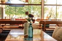a bottle with a flower in it sitting on a table at Bendemeer Hotel in Bendemeer