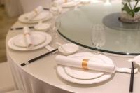 a white table with white plates and glasses on it at Chengdu Yueming Hotel,2-minute walk to Subway ,close to Kuanzhai Alley and Chunxi Road,Free laundry, Free coffee, Chengdu food,English communication well,Private travel advice in Chengdu