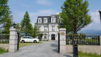 a white car parked in front of a house at Haut Rhin Villa in Zhuangwei