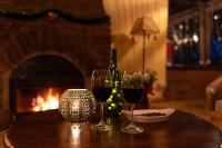 a table with two wine glasses and a bottle of wine at Rhotia Valley Tented camp in Karatu