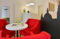 Habitación con sillas rojas y mesa blanca en INVITE Hotel Fulda City Hauptbahnhof, en Fulda
