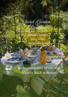 a table with food on it in a garden at B&amp;B Royal Swans in Bruges