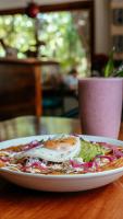 a plate of food with an egg on a table at Aldea Xaan Ha Tulum in Tulum