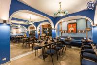 a restaurant with blue walls and tables and chairs at Pi's Hotel Sapa in Sa Pa