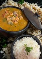 a plate of food with a bowl of soup and rice at Suítes Sabor e Mar in Angra dos Reis