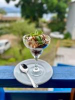 a dessert in a glass on a table with a spoon at Suítes Sabor e Mar in Angra dos Reis