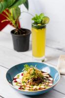 un plato de comida en una mesa con una bebida en Vallonne Vineyards, en Igatpuri