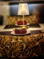a table with a lamp and a plate with two roses at The Clouds Resort Arambol, Goa in Arambol