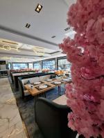 a restaurant with a large pink tree in the middle at Golden Stone Hotel Akçay in Edremit