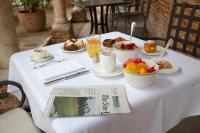 een tafel met ontbijtproducten en een krant erop bij San Clemente Palace Venice in Venetië