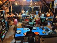 a group of people sitting at tables in a room at daTerra Baucau agroecological farm stay in Deli
