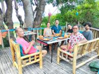 a group of people sitting at a table at daTerra Baucau agroecological farm stay in Deli