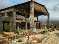 a stone building with a thatched roof at Sama Heights Resort in Dār Sawdāʼ