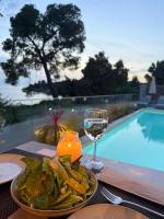 a table with a plate of food and a glass of wine at Casa Bloo Adults Only in Elia