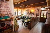 a restaurant with a fireplace and a dining room at Hotel Perlach Allee by Blattl in Munich