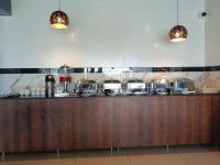 a kitchen with a counter with pots and pans at The Dritan Brookefield ITPL Main Road in Bengaluru