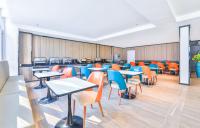 an empty classroom with tables and chairs at Hanting Hotel Beijing Daxing Caiyu in Beijing