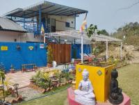 a buddha statue in front of a house at Rumis Mountain Sunset in Nainital