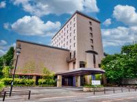 un gran edificio de ladrillo con aparcamiento en Royal Pines Hotel Yonezawa - Opening in Mar 2025, en Yonezawa