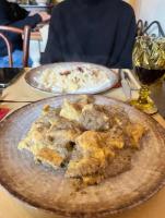 two plates of pizza on a table with a glass of wine at Al Giardino Toscano in Montecarelli