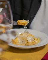a person eating food on a plate with a fork at Al Giardino Toscano in Montecarelli