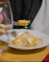 a person eating food on a plate with a fork at Al Giardino Toscano in Montecarelli