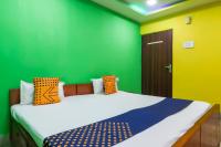 a bedroom with green and yellow walls and a bed at Hotel O Bright in Jamshedpur