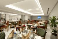 a dining room with tables and chairs and tablesktop at MADEN Al Rawda مادن الروضة in Al Madinah