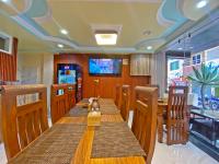 a dining room with a long wooden table and chairs at Hotel Five Season Inn in Kathmandu