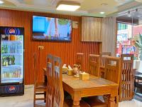 a dining room with a table and a tv on a wall at Hotel Five Season Inn in Kathmandu