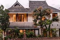 a house with a shingled roof at M ORIGINAL VILLA in Jinghong