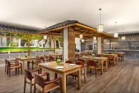 a dining room with wooden tables and chairs at Days Hotel by Wyndham Chengdu Renmin South Road in Chengdu