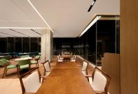 uma sala de jantar com uma mesa longa e cadeiras em Guangzhou Huayu Wanfu Hotel em Guangzhou