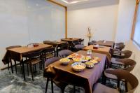 a room with tables and chairs with bowls of food on them at Hotel Sterling Executive in Navi Mumbai