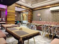 a restaurant with tables and chairs in a room at Hotel Tapovan Hills in Rishīkesh