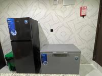 a refrigerator and a trash can in a room at Morgan Hill Residence in Abuja