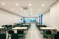 uma sala de aula vazia com mesas e cadeiras numa sala em Red Sea Grand Hotel (Huafa Ice World, Shenzhen World Exhibition & Convention Center Branch) em Fenghuangwei