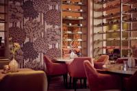 a restaurant with tables and chairs and a wallpaper at Van der Valk Hotel Gorinchem in Gorinchem