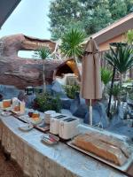 a table with food and an umbrella in front of a resort at Suwanna Riverside in Chai Nat