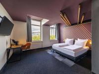 Ένα ή περισσότερα κρεβάτια σε δωμάτιο στο B&amp;B HOTEL Bochum Hbf-Nord