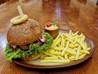 a plate with a sandwich and french fries on a table at Country Saloon Belá in Belá