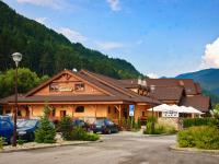 a large building with cars parked in a parking lot at Country Saloon Belá in Belá