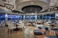 a restaurant with tables and chairs and windows at Divi Little Bay Beach Resort in Philipsburg