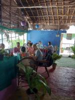 a group of people sitting at tables in a restaurant at UmaNatarajan Residency in Tiruvannāmalai