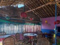 a dining room with tables and chairs and chandeliers at UmaNatarajan Residency in Tiruvannāmalai