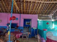 a dining room with pink and blue walls and a table at UmaNatarajan Residency in Tiruvannāmalai