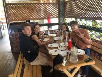 een groep mensen die aan een tafel in een restaurant zitten bij e34 Café, Restaurant & Hotel Koslanda Hideaway with a Private Natural Pool in Koslanda